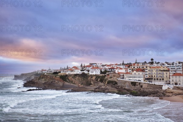 Beautiful sunset at Praia das Macas beach in Portugal. The village overlooks the ocean with