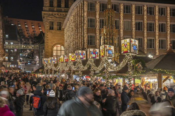 Nuremberg Christmas Market illuminated in the evening with the Beautiful Fountain and Town Hall,
