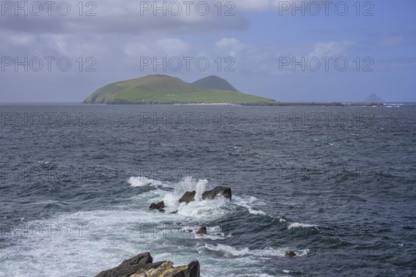Waves blaze against rocks in the background Great Blasket Island, Blasket Center Viewing Platform,