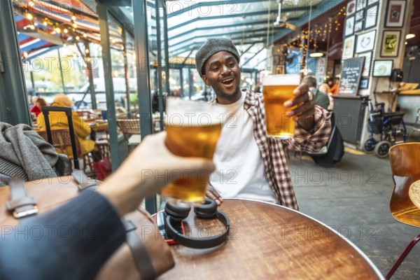 Friends enjoying a celebratory moment, raising refreshing beer glasses for a toast at a vibrant