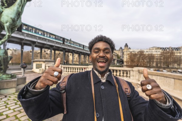 Enthusiastic young black man expressing happiness and positivity with a thumbs up gesture,
