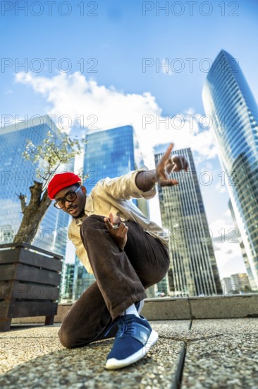 Young black man in a red beret and glasses posing confidently with hands gesturing, expressing