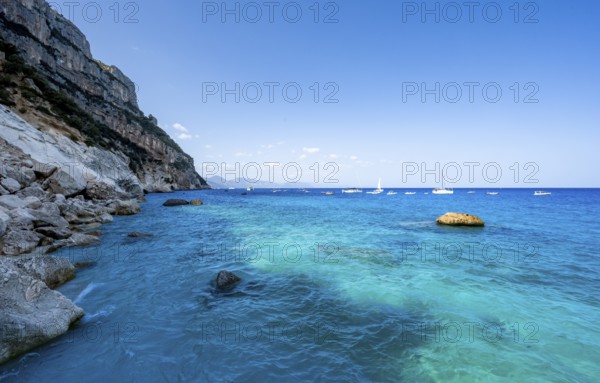 Light blue clear sea on a dream beach on Cala GoloritzÃ©, picturesque rocky coast, cliffs, Golfo di