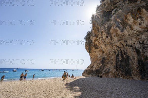 Sandy beach beach and steep cliffs with caves at Cala Luna, Sun Star, Golfo di Orosei, Baunei,
