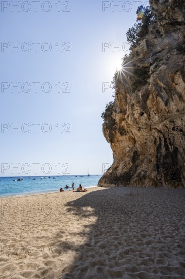 Sandy beach beach and steep cliffs with caves at Cala Luna, Sun Star, Golfo di Orosei, Baunei,
