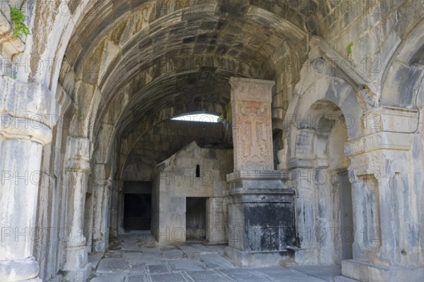 Vaulted stone building with decorated arches and historic reliefs in old walls, Haghpat monastery,