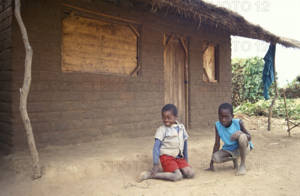 Children in front of a clay hut on the side of the road, boys, Salima, Malawi, Africa, June 2000,