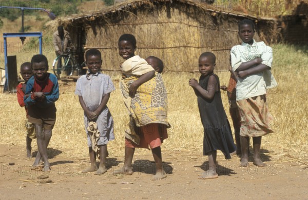 Children in front of a straw hut on the side of the road, Bwangu Mzimba, Malawi, Africa, June 2000,