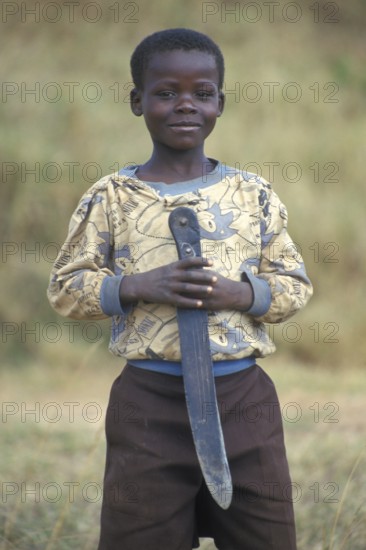 Portrait of a little boy with a big knife, Bwangu Mzimba, Malawi, Africa, June 2000, vintage,