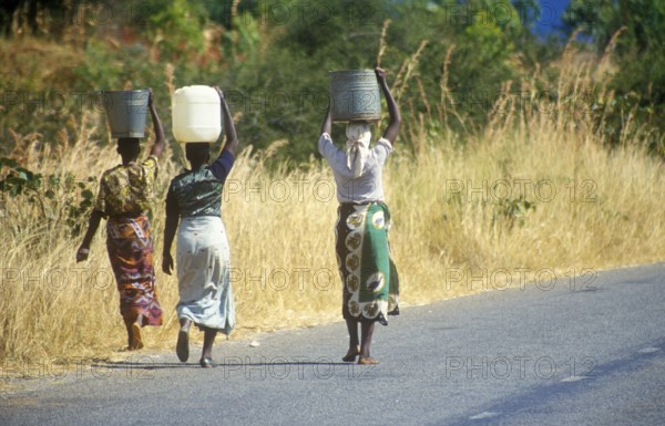 Women balancing baskets on their heads, Bwangu Mzimba, Malawi, Africa, June 2000, vintage, retro,