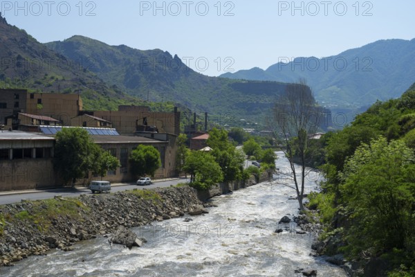 Industrial building along a river in a mountainous and green area, former copper smelter, Alaverdi,