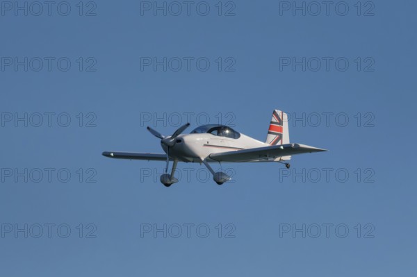 Stunt aerobatic plane performing stunts in blue sky. Concept of speed, difficulty, precision, risk,