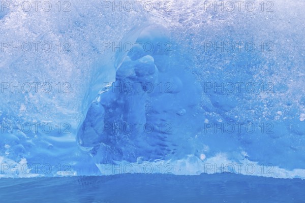 Close-up of blue ice floe calved from Lilliehöökbreen glacier drifting in the Lilliehöökfjorden,