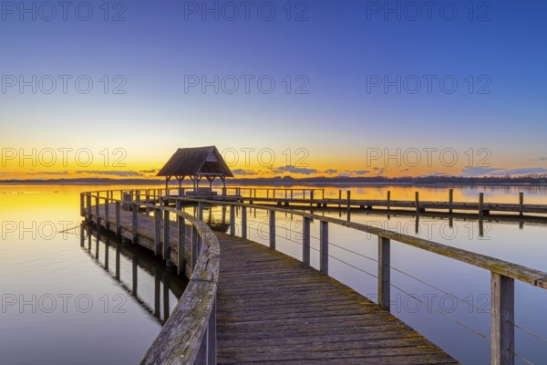 Wooden jetty on Lake Hemmelsdorf / Hemmelsdorfer See at sunrise in spring near LÃ¼beck,