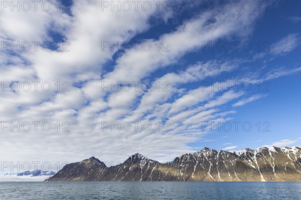 White clouds over mountains along Lilliehöökfjorden, fjord branch of Krossfjorden in Albert I Land,