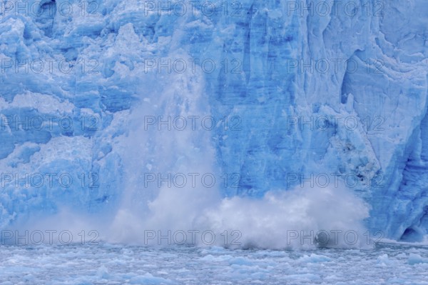 Ice chunk breaking from edge of the calving Lilliehöökbreen glacier into Lilliehöök Fjord,
