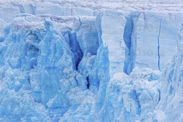 Calving glacier wall showing crevasses, deep cracks in blue ice, Lilliehöök Fjord, Krossfjorden in
