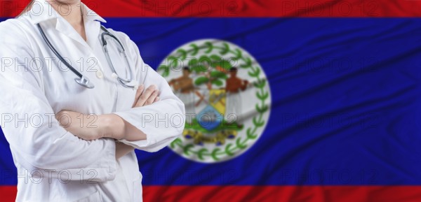 Doctor with crossed arms on Belize flag. Belizean health and care concept. Female doctor on Belize