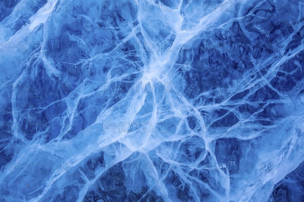 Close-up of blue ice, made of compressed snow, structure showing cracks and fissures inside