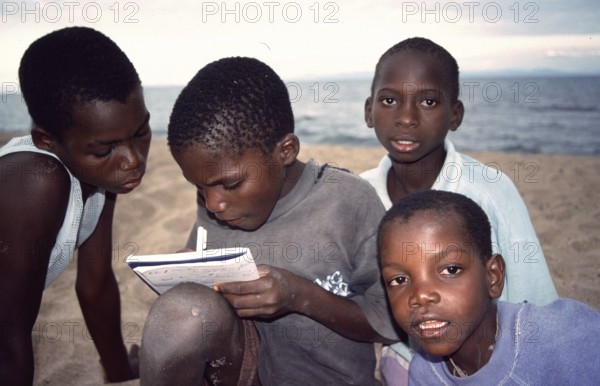 Local boys write down their addresses, Chitimba, Lake Malawi, Malawi, Africa, July 2000, vintage,
