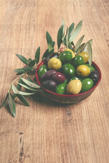 A mixture of olives, varieties of chalkidiki, Verdi giganti and Kalamata, in a bowl, top view, no