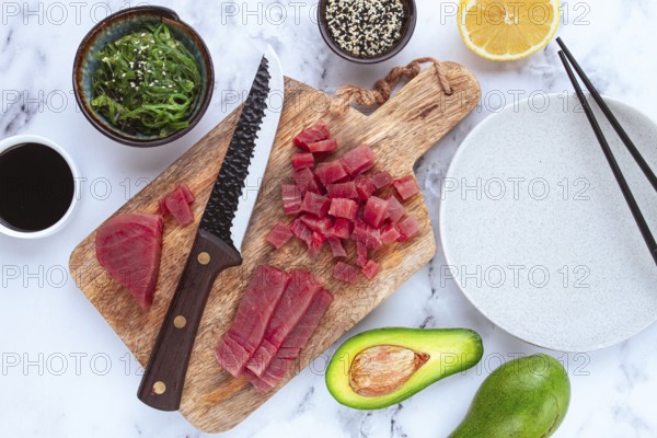 Cooking fresh tuna with ingredients on a marble countertop, ingredients for making sushi and tuna