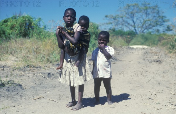 Girl with younger siblings near Kande Beach, Malawi, Africa, July 2000, vintage, retro, old,