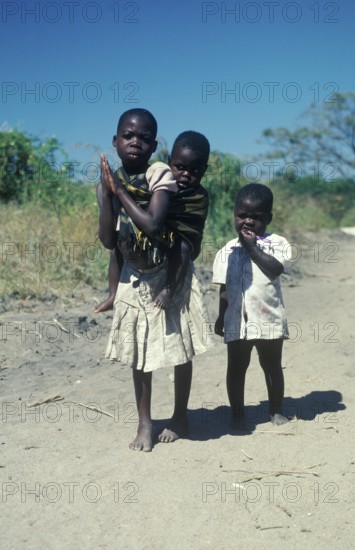 Girl with younger siblings near Kande Beach, Malawi, Africa, July 2000, vintage, retro, old,