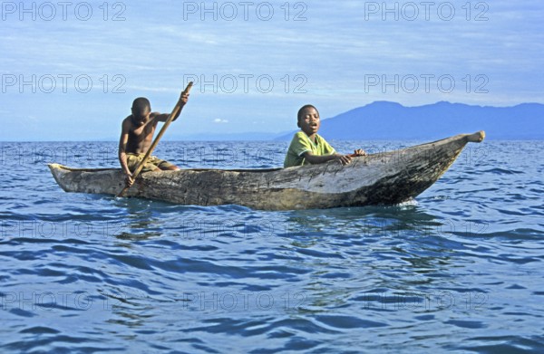 Two boys in a dugout on Lake Malawi, Malawi, Africa, July 2000, vintage, retro, old, historic