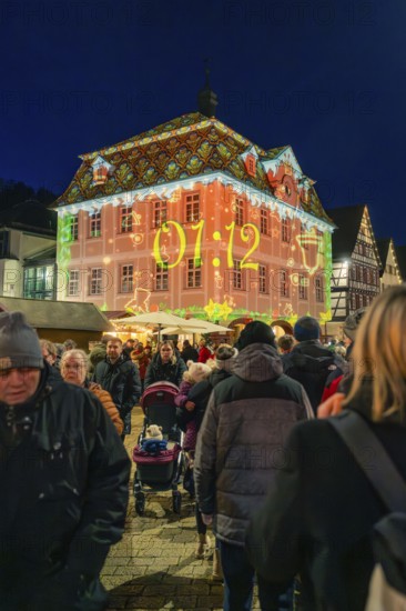 Projection with time on a building during a night-time Christmas market, Christmas market 2025,