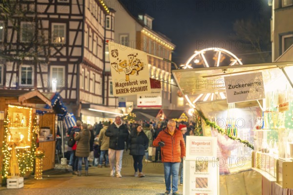 Night market with stalls selling stomach bread and cotton candy, Christmas market 2025, Nagold,
