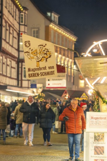 People buy stomach bread at a busy evening Christmas market, Christmas market 2025, Nagold, Black