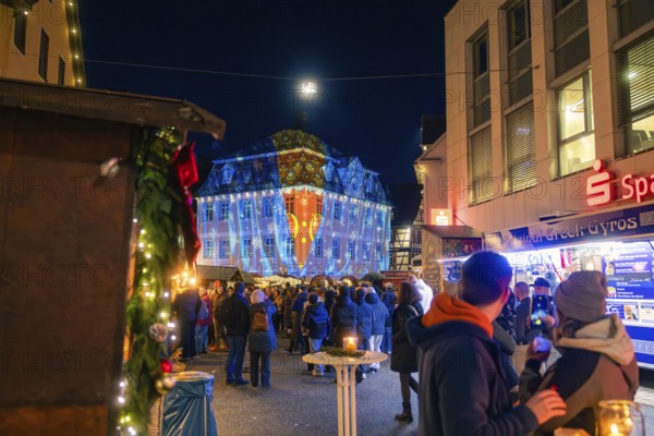 Coloured projections on a building during a night-time visit to the Christmas market, Christmas
