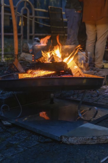 A burning fire provides warmth and comfort on a cool night, Aidlingen Christmas Market, Böblingen