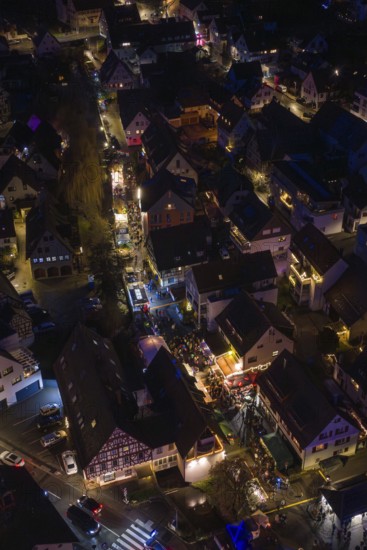 Village at night with tight street lights and festive lights, Aidlingen Christmas market, Böblingen