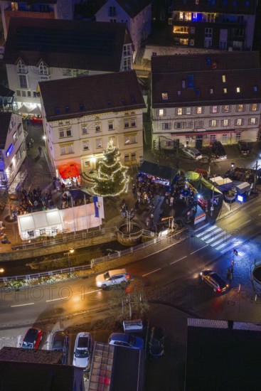 Night view with decorated Christmas tree and people gathered, Aidlingen Christmas market, Böblingen