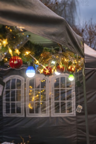 Festive Christmas decoration with lights and balls hanging on a tent, Aidlingen Christmas market,