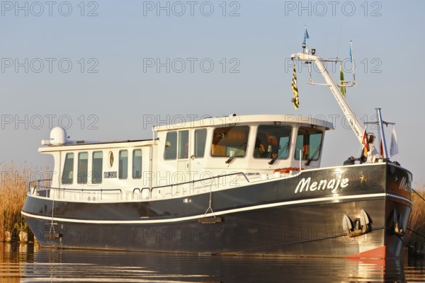 Residential ship on the Peene, tourism, alternative form of living, life on the water with a ship,