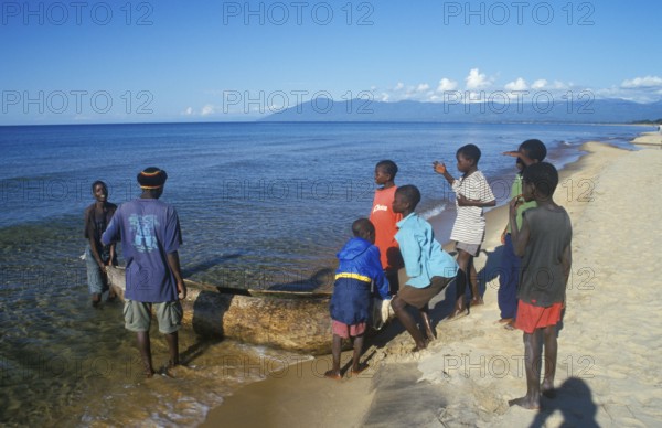 Local men and boys with a dugout near Kande Beach on Lake Malawi, Malawi, Africa, July 2000,