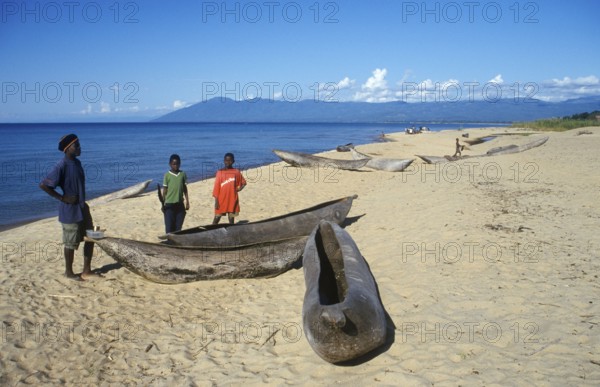 Local man and boy with canoes near Kande Beach on Lake Malawi, Malawi, Africa, July 2000, vintage,