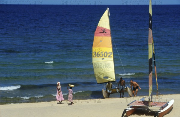 Local woman and tourist with catamaran on Lake Malawi, Kande, Malawi, Africa, July 2000, vintage,