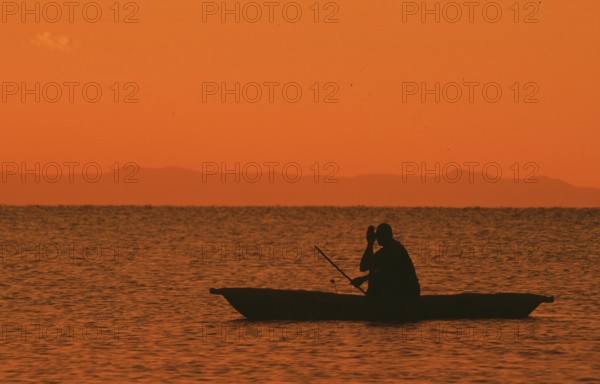 Sunrise over Lake Malawi, man in dugout, Kande, Malawi, Africa, July 2000, vintage, retro, old,