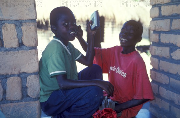Two local boys with Walkman in a village near Kande, Lake Malawi, Malawi, Africa, July 2000,