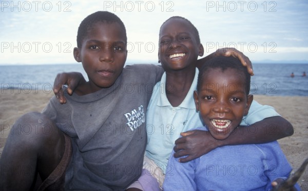 Three boys posing for camera, Chitimba, Lake Malawi, Africa, July 2000, vintage, retro, old,