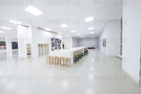 Large, bright room with long tables and chairs, minimalistic modern furniture, Open Horizons