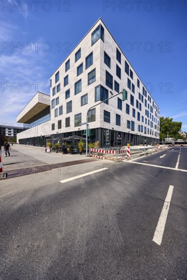 Pedestrian zone, road, lanes, road markings directional arrow, traffic light, commercial building,