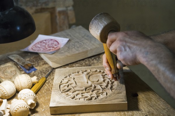 Craftsmanship in a workshop where wood is carved and hand tools are visible, Old Town, Sharambeyan
