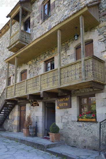 Rustic stone house with wooden balconies and flower box in traditional design, Old Town,