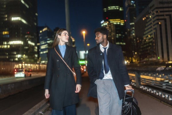 Professional associates discussing work while strolling through a modern urban environment