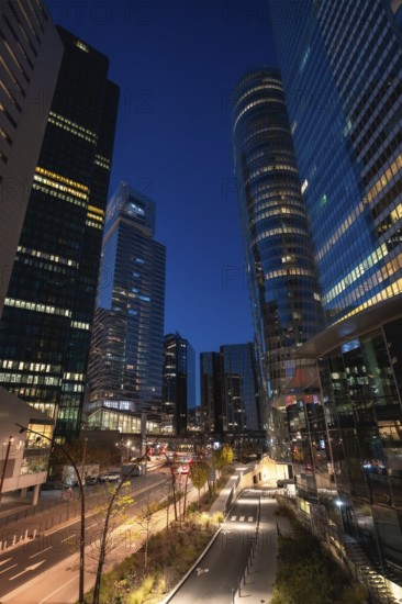 La defense financial district in paris at twilight, modern glass skyscrapers with illuminated